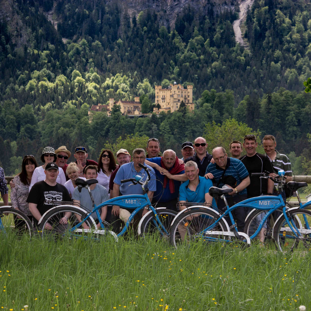 Group of tourists on bike tour behind Schloss Hohenschwangau